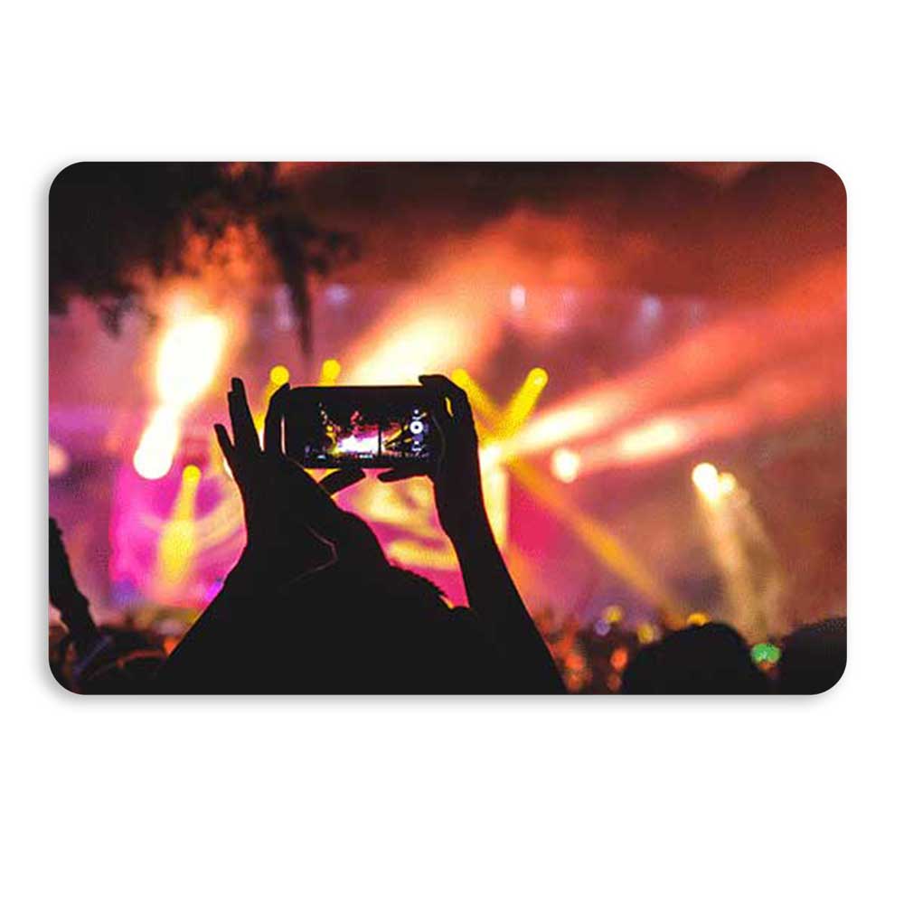 hands holding a cell phone, taking a picture at a concert